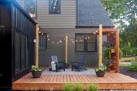 gray house backyard deck lights posts