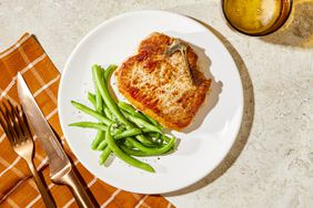 Pork chops on plate with green beans