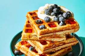 a stack of waffles topped with blueberries