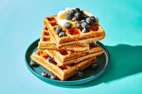 Waffles with blueberries, whipped cream and syrup 