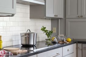 induction kitchen stove top with gray cabinets