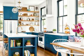 Kitchen with wooden floors and dark blue cabinets