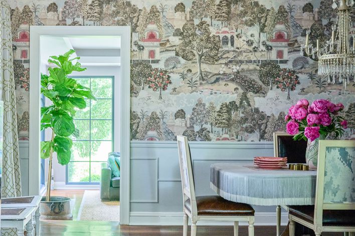 dining room with fringe tablecloth and mural wallpaper