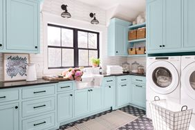 laundry room with blue cabinetry