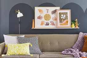 living room with grey wall detail and warm artwork