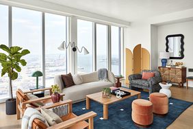 Real Simple Home living room with curvaceous furniture and shades of blue and orange