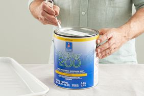 loosening paint can lid with tool
