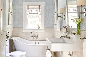 master bathroom with patterned wallpaper and white tile