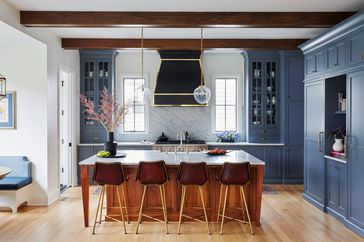 traditional kitchen with blue cabinets and wood island