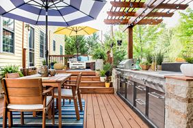 multi-level back deck with outdoor dining, kitchen and lounge areas