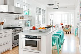 modern white open kitchen mint green stools accents