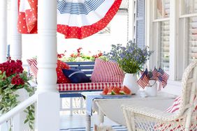 patriotic bunting on white porch with little dog
