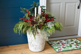 ceramic planter on porch with holiday greenery