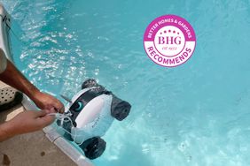 Person placing Aiper Seagull SE Cordless Robotic Pool Cleaner in pool