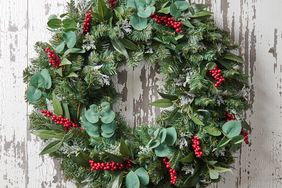 Red berry accented wreath rustic wood