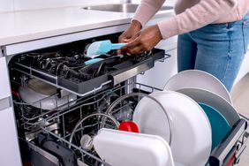 woman unloading the dishwasher