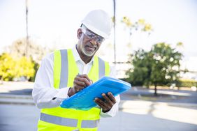 Man completing property survey and inspection