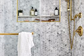 Hexagon tiled shower with niche and brass accent