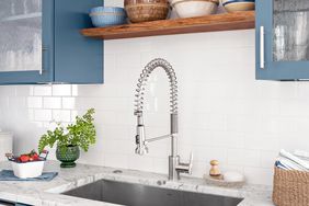 statement blue kitchen tour display shelves sink faucet