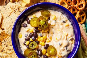 board of Tex-Mex Cheese Dip with salsa, guacamole, and various chips