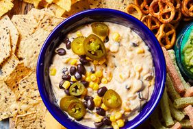 board of Tex-Mex Cheese Dip with salsa, guacamole, and various chips