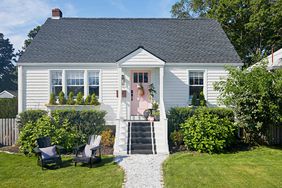 exterior white cape cod black painted front steps pink door