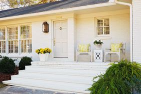 white painted brick ranch exterior front porch steps yellow