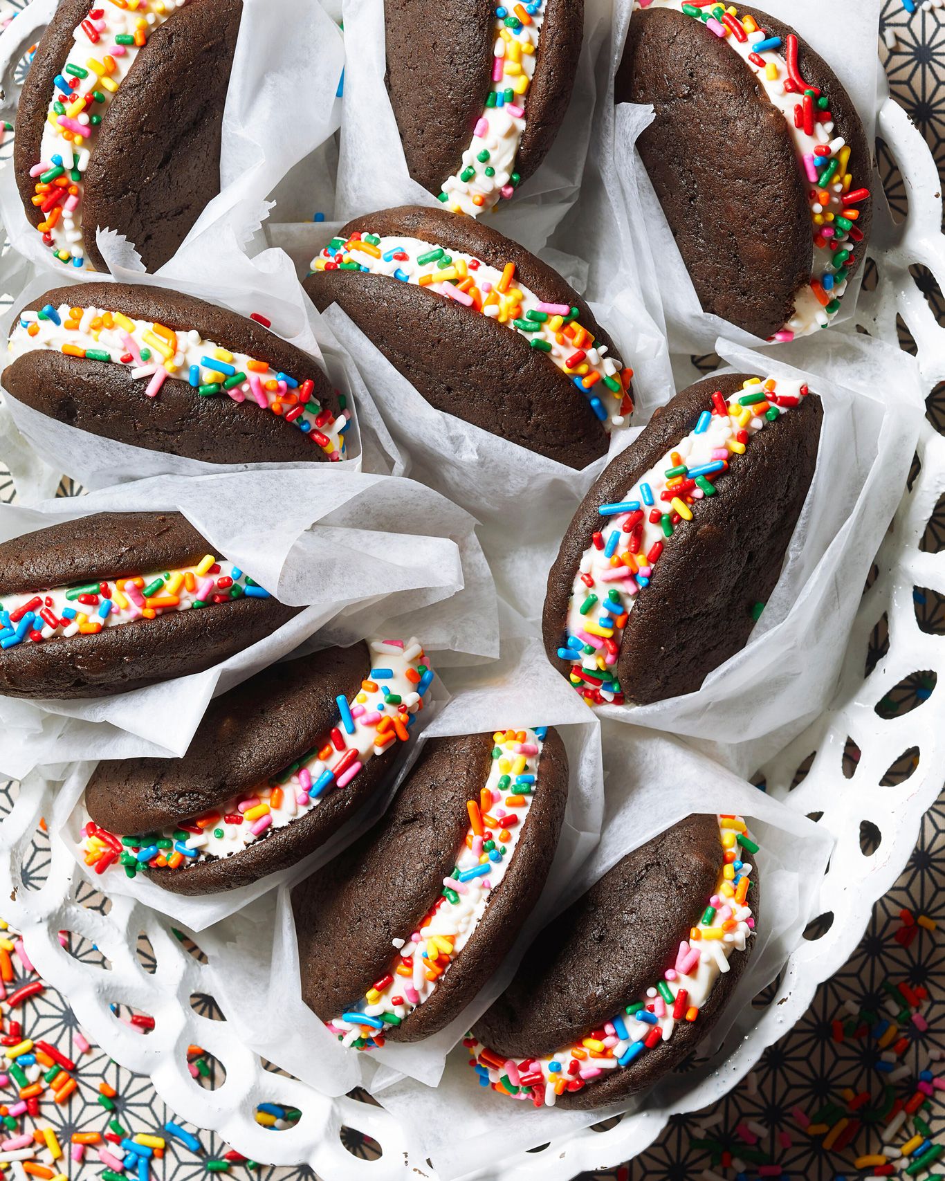 Chocolate whoopie pies with cream filling and coated in rainbow sprinkles
