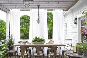 a neutral deck with a long table and white sheer curtains