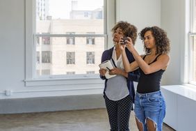 Young Women Inspecting a Modern Apartment or Office